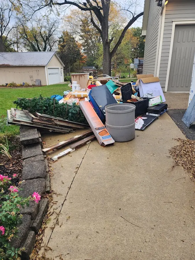 Dumpster being loaded with debris for 10 Yard Dumpster Rental in Wales